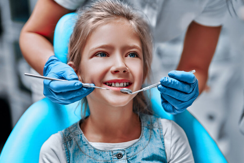 Cute little girl in the dentist chair, close up view