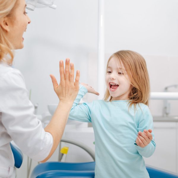 My little assistant. Trained capable distinguished doctor making friends with a girl after running some procedures and making her smile healthy