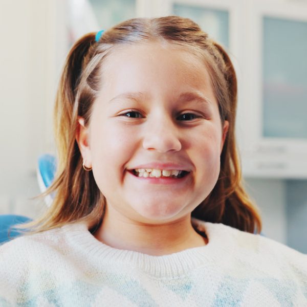 Happy girl, portrait and patient with teeth for dental hygiene, checkup or appointment at clinic. Child, kid or smile with mouth for medical orthodontist, tooth surgery or oral and gum healthcare.