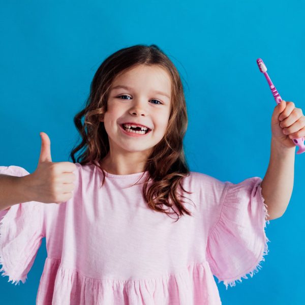 little girl with a toothbrush in dentistry